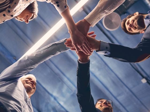 Group of executive placing their hands together