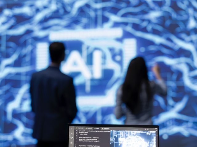 Focus on complex AI brain models being analyzed on laptop by developers