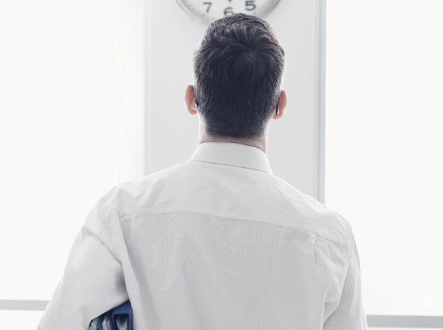 Businessman staring at the clock