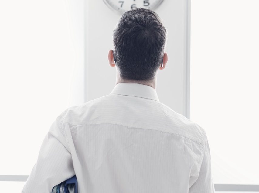 Businessman staring at the clock