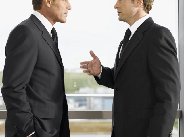 two-businessmen-talking-in-office two-businessmen-talking-in-office