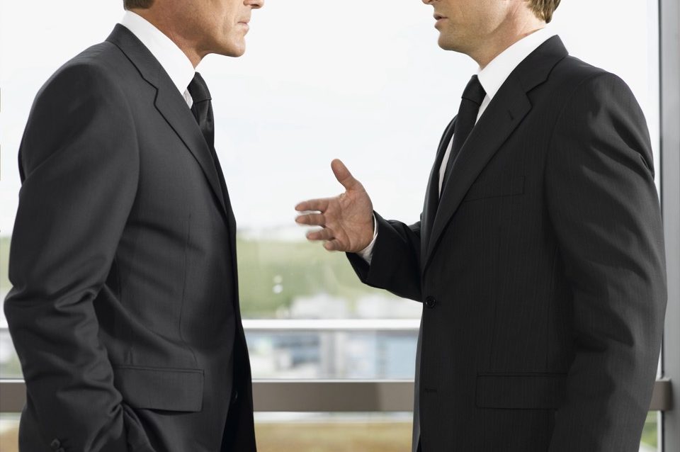 two-businessmen-talking-in-office